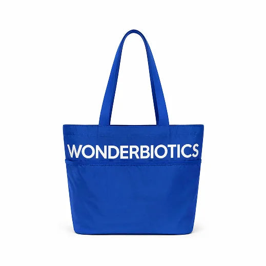 Blue tote bag with 'Wonderbiotics' logo on a white background