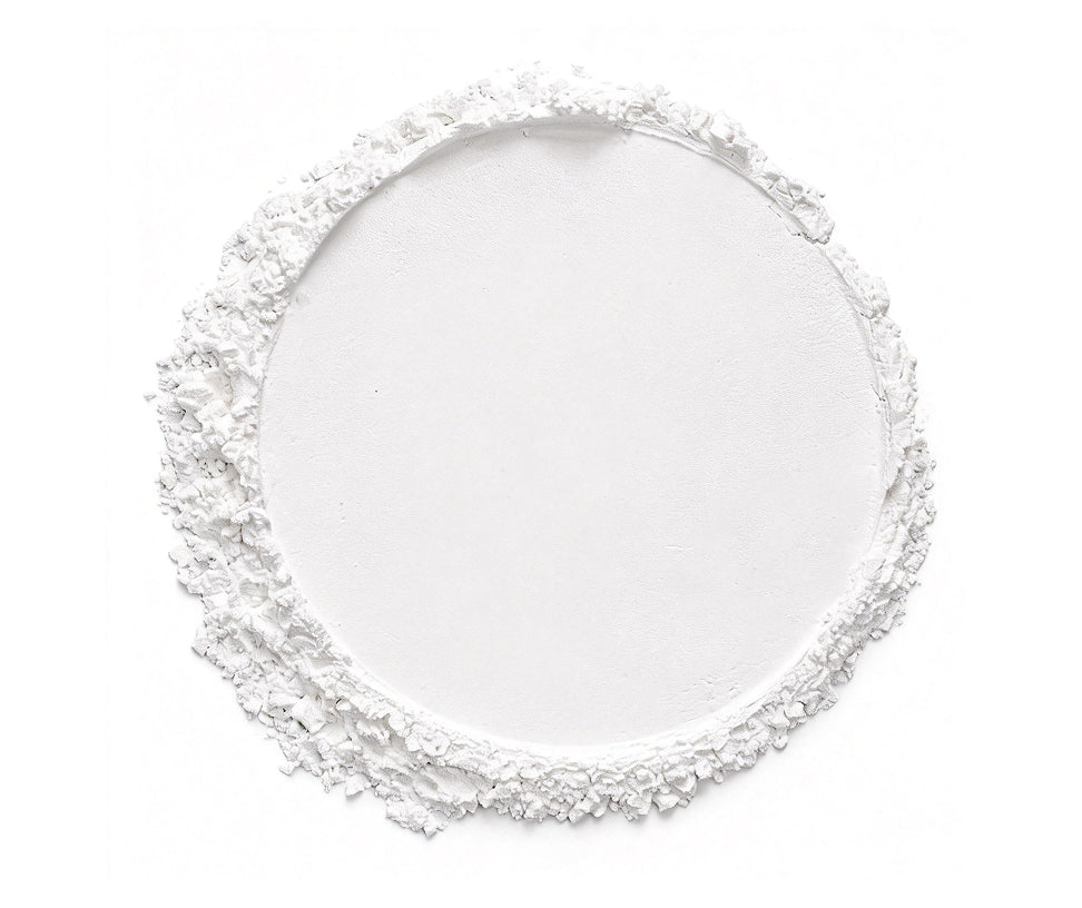 Decorative white plate with intricate border on a white background