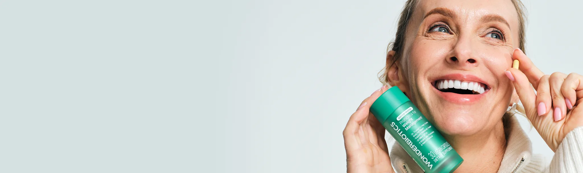 Woman holding a WonderBiotics bottle