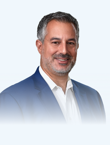 Man wearing a blue suit and white shirt on a light gray background